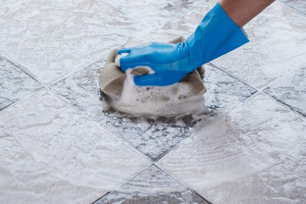 Cleaning the tile floor.